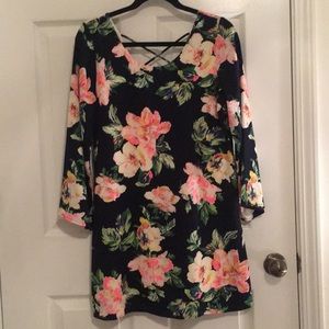 Long sleeve navy sheath with flower detail.